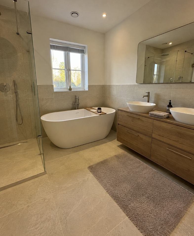 Bathroom with a freestanding bath, twin counter top basins and a walk in shower