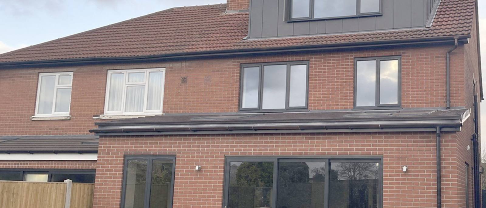 Large two storey rear extension in matching red brick