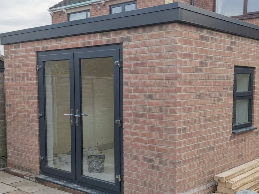 Brick rear extension with french doors and a flat roof