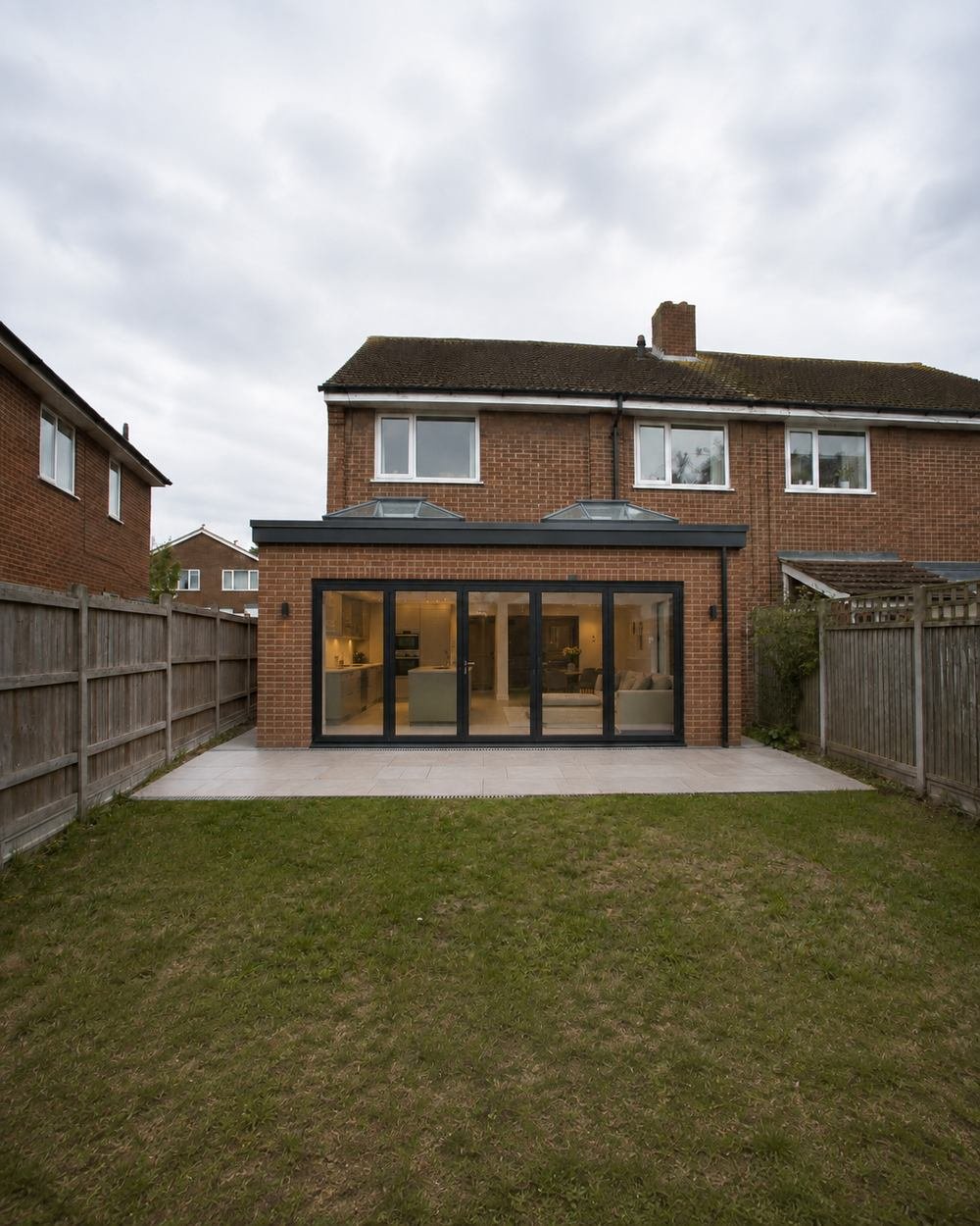 Brick rear extension with full width bifold doors and two roof lanterns