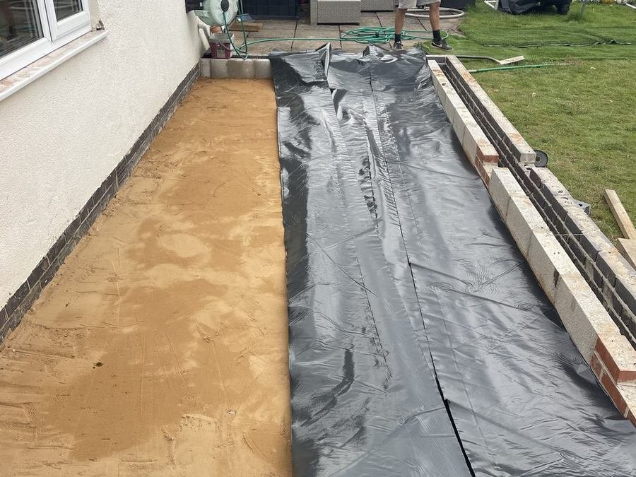Extension footprint dug out with the membrane laid ready for concrete