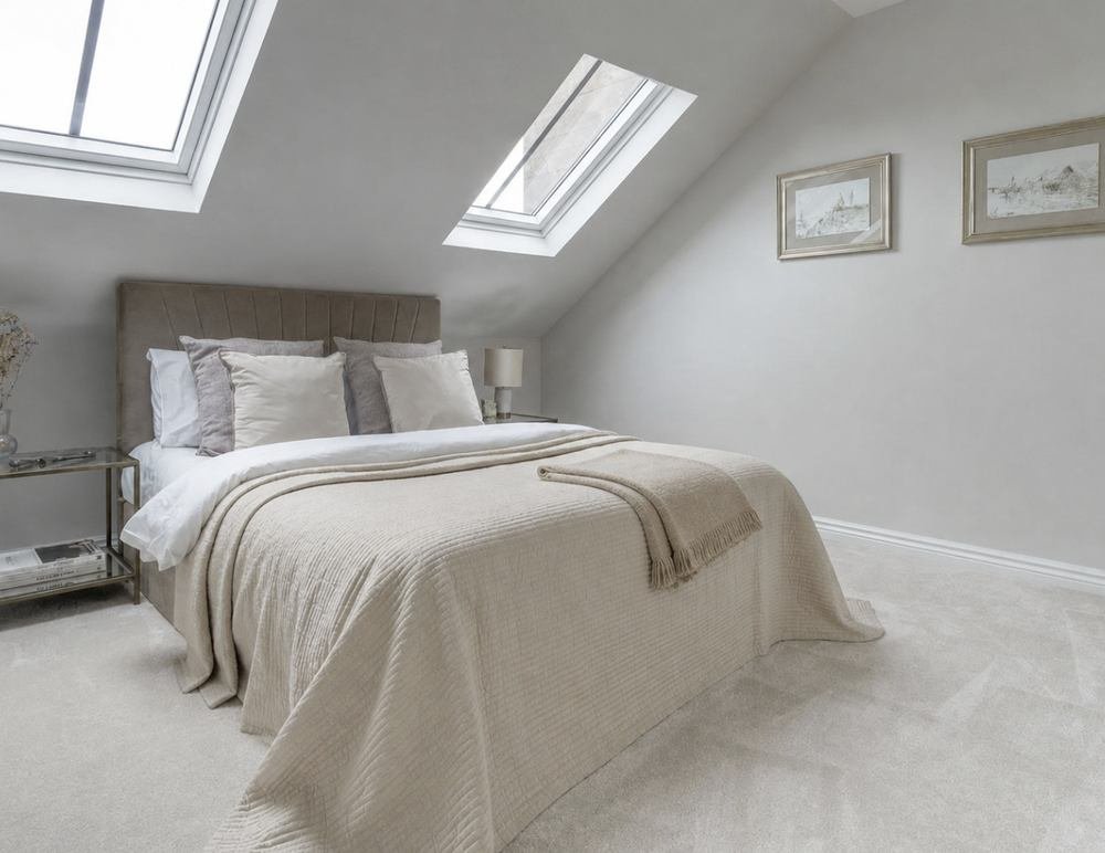 Finished loft bedroom with velux windows and fitted carpet