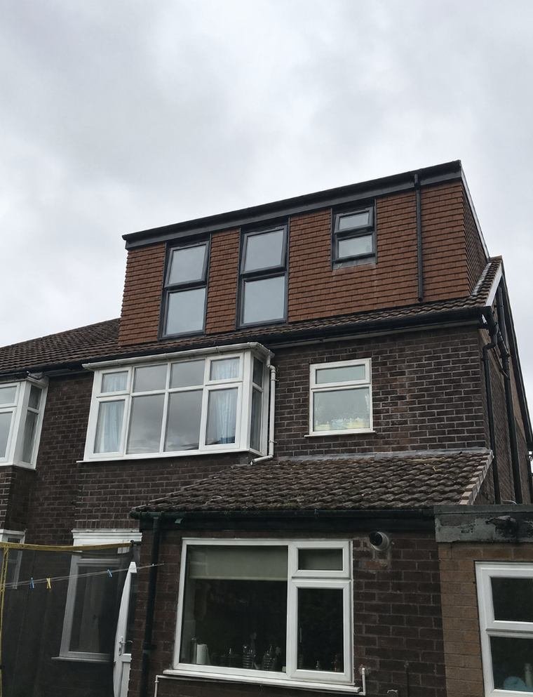 Tile hung rear dormer with three windows across the back