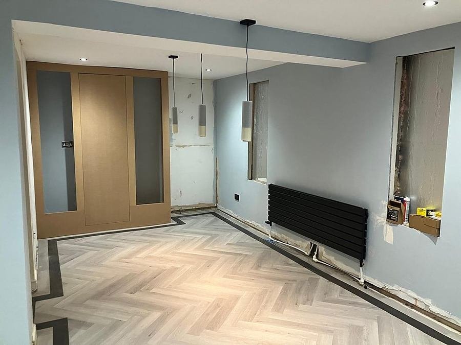 New oak doors and herringbone flooring in a refurbished room